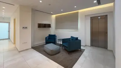 a lobby with two blue chairs and a table at Vivo Mare Beachfront Villas - Seashell in Ayia Napa