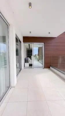 an empty living room with sliding glass doors at Vivo Mare Beachfront Villas - Vista in Ayia Napa