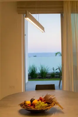 a bowl of fruit sitting on a table with a window at Sea Pearl Beachfront Villas - Breeze in Ayia Napa