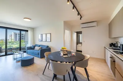a kitchen and living room with a table and chairs at Sunset Gardens in Limassol