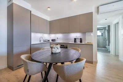 a kitchen and dining room with a table and chairs at Sunset Gardens in Limassol
