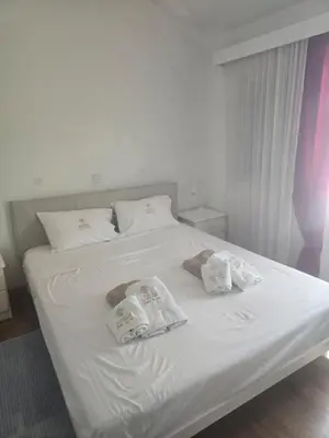 a white bed with two folded towels on it at Lazuli Seafront Beach House Nr18 in Larnaka