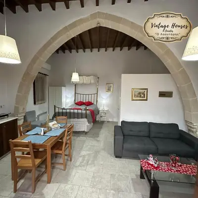 a living room with a couch and a bedroom at Omodos vintage houses in Omodos
