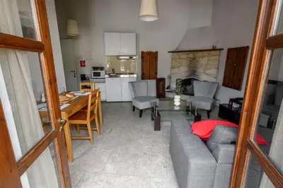 a living room with a couch and a table at Omodos vintage houses in Omodos