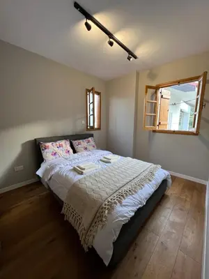 a bedroom with a large bed with a window at Eftis - Renovated Traditional House in Omodos