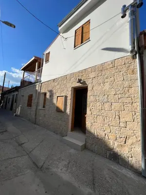 a brick building with a door on the side of it at Eftis - Renovated Traditional House in Omodos