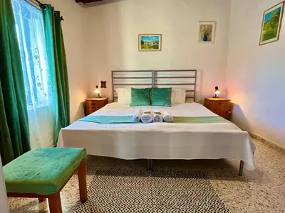 a bedroom with a bed with two towels on it at Cottage Apartment Othellos in Kalavasos