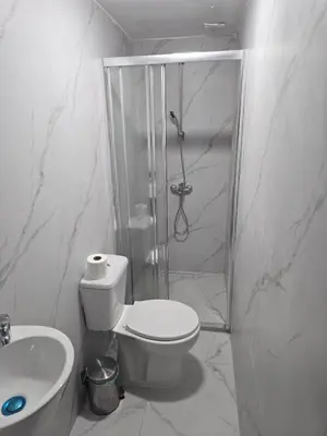 a bathroom with a shower and a toilet and a sink at Limassol Center Studios in Limassol