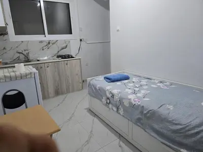 a bedroom with a bed with flowers on it at Limassol Center Studios in Limassol