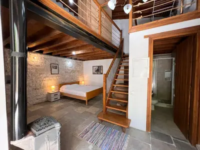a bedroom with a bunk bed and a staircase at King's house in Lofou