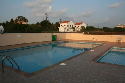 a large swimming pool on top of a building at Nissi Villa in Ayia Napa