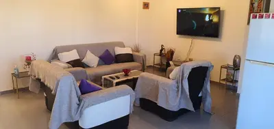 a living room with a couch and a table at STEFARIS PROPERTIES 'sioukris court' in Larnaka