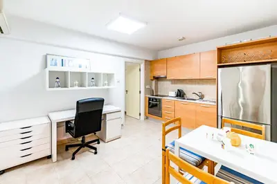 a kitchen with a desk and a chair in it at Villa Elliana by Ezoria Villas in Protaras
