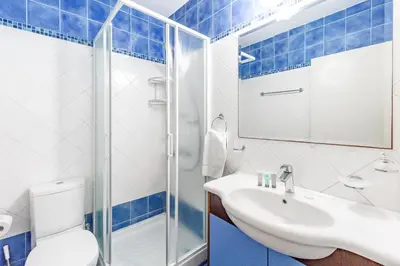 a bathroom with a toilet and a sink and a shower at Villa Elliana by Ezoria Villas in Protaras