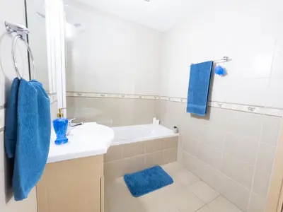 a bathroom with a sink and a tub and a shower at Pandora Holiday Apartment Ayia Napa in Ayia Napa