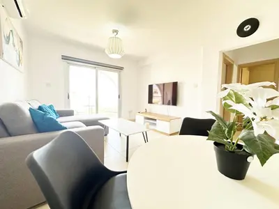 a living room with a couch and a table at Pandora Holiday Apartment Ayia Napa in Ayia Napa