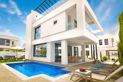 a house with a swimming pool in front of it at Villa Amity in Protaras