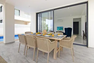 a dining room with a table and chairs at Villa Amity in Protaras