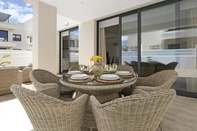a dining room with a table and wicker chairs at Villa Talia in Protaras