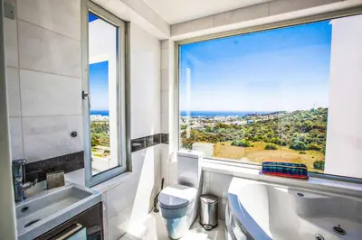 a bathroom with a tub and a window with a view at Villa Pallas KO1 in Protaras