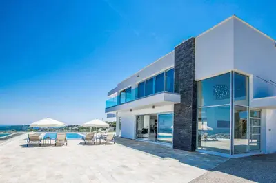 a large house with a patio and a swimming pool at Villa Pallas KO1 in Protaras