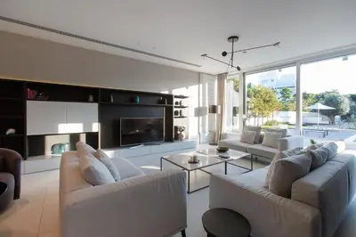 a living room with two couches and a fireplace at Vivo Mare Beachfront Villas - Emerald in Ayia Napa