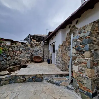 a stone building with a toilet in a courtyard at THE ROCK HOUSE - Beautiful countryside with mandarins oranges and olive trees,. Near Limassol at Eptagonia village. in Ephtagonia