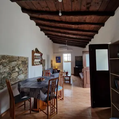 a kitchen and dining room with a table and chairs at THE ROCK HOUSE - Beautiful countryside with mandarins oranges and olive trees,. Near Limassol at Eptagonia village. in Ephtagonia