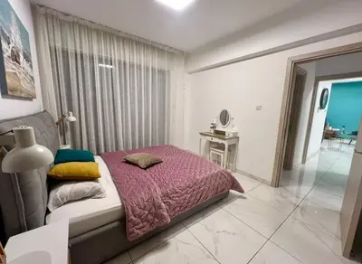 a bedroom with a bed and a table in it at Cosmos Residence in Paralimni
