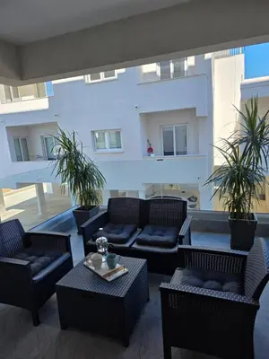 a patio with couches and chairs and a table at Cosmos Residence in Paralimni
