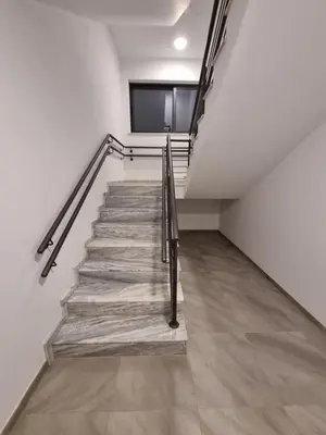 a staircase in a building with a tv on the wall at Cosmos Residence in Paralimni