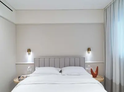 a bedroom with a large bed and a window at LIV Mackenzie Beach Suites Larnaca ADULTS ONLY in Larnaka