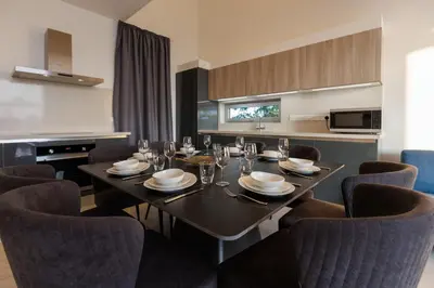 a dining room with a table and chairs at Napa Hills Seaview Villas - Iris in Ayia Napa