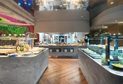 a restaurant with two counters with food on display at NYX Hotel Limassol in Limassol