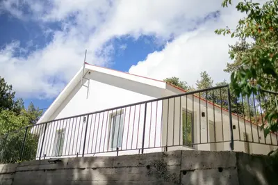 a white building with a metal fence on top at Legacy 1930s in Prodromos