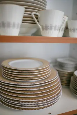 a stack of plates and bowls on a shelf at Legacy 1930s in Prodromos