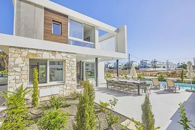 a house with a patio with a table and chairs at Nissi Kube KB1 in Ayia Napa