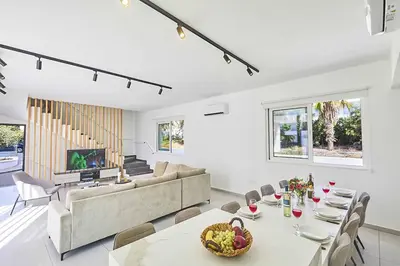 a living room with a couch and a table at Nissi Kube KB1 in Ayia Napa