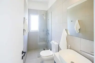 a bathroom with a toilet and a sink and a shower at Nissi Kube KB1 in Ayia Napa