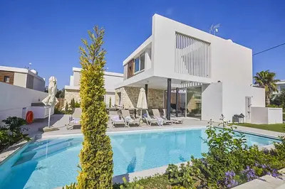 a house with a swimming pool in front of a house at Nissi Kube KB1 in Ayia Napa