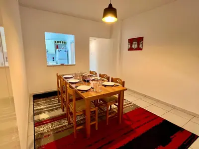 a dining room with a wooden table and chairs at Two Bedroom City Seaside Apartment in Limassol