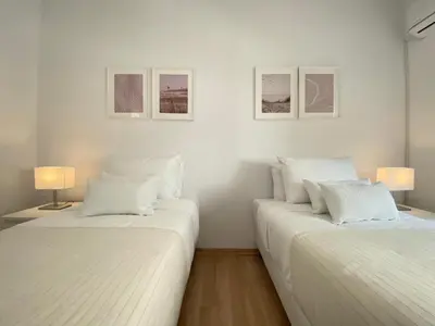 two white beds in a room with two lamps at Phaedrus Living Down Town Flat Stephania 302 in Limassol