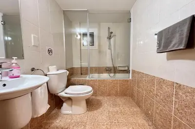 a bathroom with a toilet and a sink and a shower at Villa White Star - 100m from Serena Beach in Protaras
