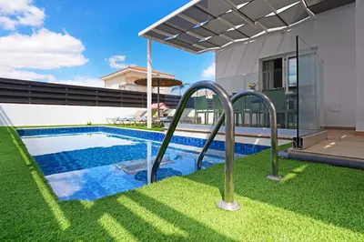 a swimming pool in the backyard of a house at Villa White Star - 100m from Serena Beach in Protaras
