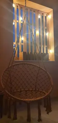 a basket chair in a room with a window at STEFARIS PROPERTIES 