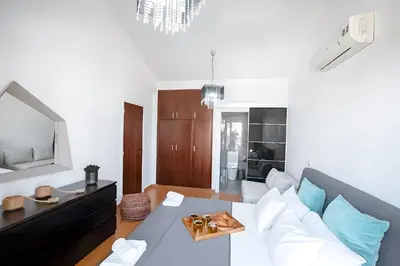 a living room with a white couch and a table at Blue Crystal Seaview in Protaras