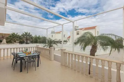 a patio with a table and chairs on a balcony at Blue Crystal Seaview in Protaras