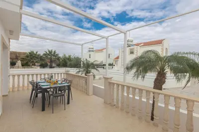 a patio with a table and chairs on a balcony at Blue Crystal Seaview in Protaras
