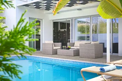 an outdoor patio with a swimming pool and a house at Villa Catalina in Ayia Napa