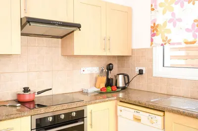 a kitchen with a sink and a stove top oven at Villa Mandy in Protaras